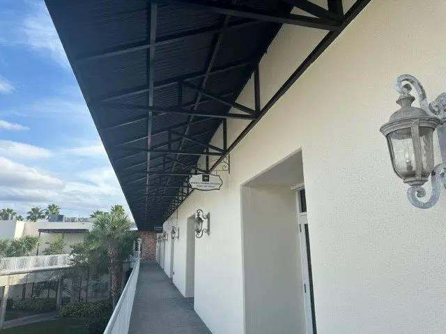 A balcony with a black awning over the top of it.